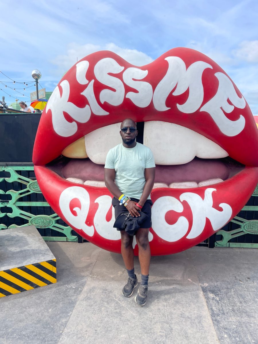 Rasheed in front of the giant Kiss Me Quick lips at Glastonbury on Sea